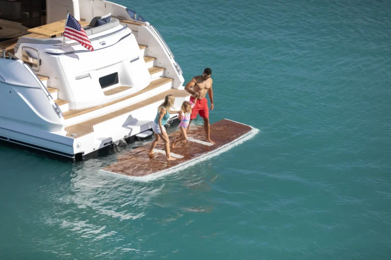 Princess X65 family playing on swim platform