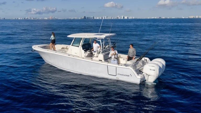 White sport fishing boat on blue ocean with four people fishing and a city skyline in the distance?