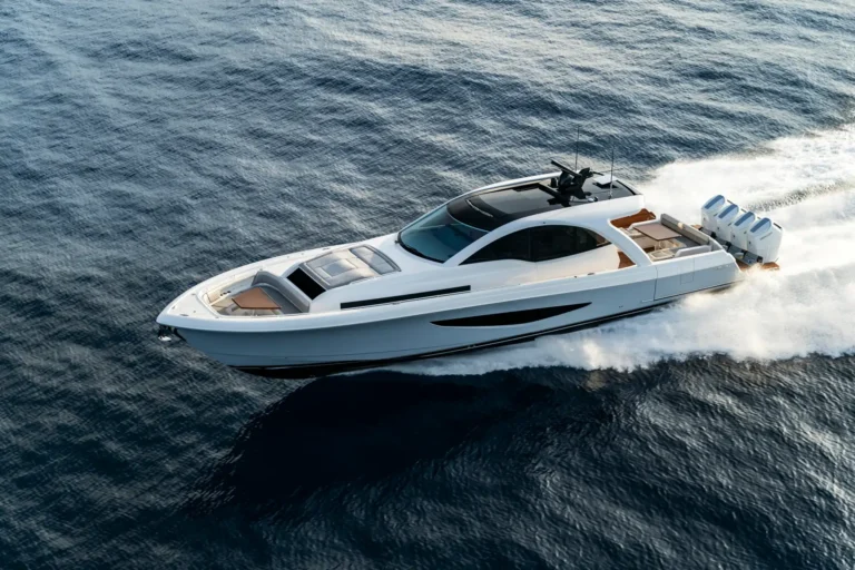 White luxury speedboat cruising at sea, leaving a white wake behind it