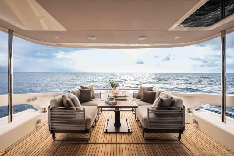 aft cockpit sitting with twin modular sofas and extended dining table