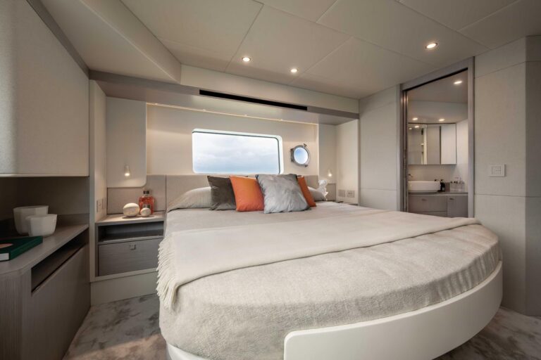 facing bed and window with porthole in vip cabin of navetta 50