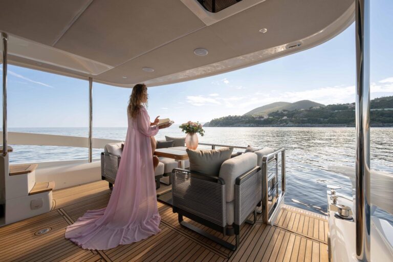 woman in pink dress enjoying the cockpit view with a book